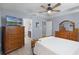 Spacious main bedroom features tray ceiling, ceiling fan, wood furniture, and mounted television at 1139 Seedorf Dr, Winter Haven, FL 33881