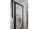 Modern shower features glass doors, rainfall shower head, white tile, and unique mosaic at 1139 Seedorf Dr, Winter Haven, FL 33881