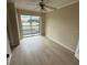 Sunlit bedroom boasts wood-look floors and access to a private balcony at 115 Oyster Bay Byu # 115, Altamonte Springs, FL 32701