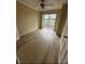 Bright bedroom with wood-look flooring and sliding glass doors to balcony at 115 Oyster Bay Byu # 115, Altamonte Springs, FL 32701