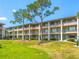 Exterior view of the community buildings with balconies and green lawns at 115 Oyster Bay Byu # 115, Altamonte Springs, FL 32701