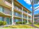 Three-story condo building featuring private balconies and lush landscaping at 115 Oyster Bay Byu # 115, Altamonte Springs, FL 32701