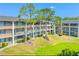 A charming condo complex with a manicured lawn and mature trees at 115 Oyster Bay Byu # 115, Altamonte Springs, FL 32701
