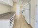 Functional kitchen with white cabinetry and neutral countertops at 115 Oyster Bay Byu # 115, Altamonte Springs, FL 32701