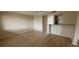 Open living room with wood-look floors seamlessly connects to the kitchen at 115 Oyster Bay Byu # 115, Altamonte Springs, FL 32701