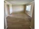 Bright living room featuring wood-look flooring and a large window at 115 Oyster Bay Byu # 115, Altamonte Springs, FL 32701
