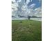 Spacious backyard featuring a lush lawn and white fencing offering privacy at 12372 Stone Bark Trl, Orlando, FL 32824