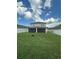 Expansive backyard featuring a screened-in patio and verdant lawn enclosed by a white privacy fence at 12372 Stone Bark Trl, Orlando, FL 32824