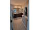 Bathroom featuring a large vanity with a large mirror and artwork on the walls at 12372 Stone Bark Trl, Orlando, FL 32824