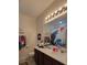 Bathroom featuring a double vanity, large mirror, and a shower curtain with an anime design at 12372 Stone Bark Trl, Orlando, FL 32824