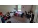 Cozy bedroom with carpet, featuring a twin bed, desk and chair set, with decoratively adorned walls at 12372 Stone Bark Trl, Orlando, FL 32824