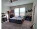 Spacious bedroom with neutral walls, carpet flooring, two windows, and ceiling fan at 12372 Stone Bark Trl, Orlando, FL 32824