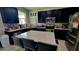Modern kitchen featuring black cabinetry, stainless steel appliances, and a large island with seating at 12372 Stone Bark Trl, Orlando, FL 32824