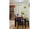 Eat-in kitchen features stainless steel refrigerator and a dining table set for four at 13 W Marbrisa Way, Kissimmee, FL 34743