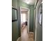 Hallway view leading to a bedroom with tiled floors and neutral walls at 13 W Marbrisa Way, Kissimmee, FL 34743