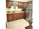 Functional kitchen featuring stainless steel appliances, tile flooring, and ample cabinet space at 13 W Marbrisa Way, Kissimmee, FL 34743