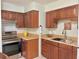 Cozy kitchen featuring wooden cabinets, stainless steel appliances and light countertops at 13 W Marbrisa Way, Kissimmee, FL 34743