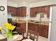 Functional eat-in kitchen featuring warm wood cabinetry and neutral countertops at 13 W Marbrisa Way, Kissimmee, FL 34743