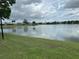Peaceful lake view with green grass at 13 W Marbrisa Way, Kissimmee, FL 34743