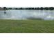 Expansive view of a tranquil lake framed by green lawn at 13 W Marbrisa Way, Kissimmee, FL 34743