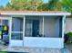 Enclosed patio with white aluminum frame, screened walls, and an outdoor entrance at 13 W Marbrisa Way, Kissimmee, FL 34743