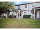 A well maintained backyard featuring a manicured lawn and covered patio at 1312 Royal St George Blvd, Davenport, FL 33896