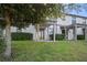 A well maintained backyard featuring a manicured lawn and covered patio at 1312 Royal St George Blvd, Davenport, FL 33896