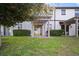 A well maintained backyard featuring a manicured lawn and covered patio at 1312 Royal St George Blvd, Davenport, FL 33896
