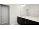 Bathroom featuring a dark vanity with single sink and an extended countertop at 1312 Royal St George Blvd, Davenport, FL 33896