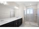 Bathroom featuring a dark vanity with double sinks and tiled walk-in shower at 1312 Royal St George Blvd, Davenport, FL 33896
