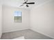 Bright bedroom featuring neutral carpeting, a ceiling fan, and a window with natural light at 1312 Royal St George Blvd, Davenport, FL 33896