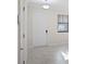 Bright entryway features neutral tile flooring, a white front door and a window with horizontal blinds at 1312 Royal St George Blvd, Davenport, FL 33896
