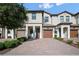 Attractive townhome with brick driveway, front garage and covered entryway at 1312 Royal St George Blvd, Davenport, FL 33896