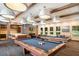 Community game room featuring pool tables, TV, lounge space, and kitchen bar at 1312 Royal St George Blvd, Davenport, FL 33896