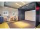 Indoor Golf simulator with seating, table, clubs, and projector screen at 1312 Royal St George Blvd, Davenport, FL 33896
