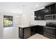 Kitchen featuring stainless steel appliances and an open dining area with a sliding glass door at 1312 Royal St George Blvd, Davenport, FL 33896