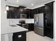 A kitchen featuring stainless steel appliances, quartz countertops, and dark wooden cabinets at 1312 Royal St George Blvd, Davenport, FL 33896