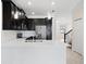 Kitchen with stainless steel appliances, white quartz countertops, and dark cabinets at 1312 Royal St George Blvd, Davenport, FL 33896