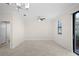 Tile floored living room with modern fan and light fixture, window, and sliding glass doors at 1312 Royal St George Blvd, Davenport, FL 33896