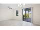 Open living space boasts tile floors, ceiling fan, and sliding glass doors to outdoor patio at 1312 Royal St George Blvd, Davenport, FL 33896