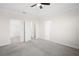 Spacious primary bedroom with multiple doors, neutral walls, and plush carpeting at 1312 Royal St George Blvd, Davenport, FL 33896