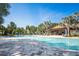 Sparkling community pool with surrounding palm trees and clear blue skies at 1312 Royal St George Blvd, Davenport, FL 33896