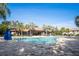 Community pool with fountains, palm trees, and nearby lounge area, perfect for relaxation at 1312 Royal St George Blvd, Davenport, FL 33896