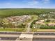 A broad aerial view showcases the commercial area, sports fields and the lush surrounding landscape at 13130 Meergate Cir, Orlando, FL 32837