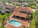 Aerial view of the property showcasing the pool, jacuzzi, outdoor living area, and view of the community at 13130 Meergate Cir, Orlando, FL 32837