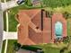 Aerial view of the home showcasing the roof, patio, pool area, landscaping, and proximity to neighbors at 13130 Meergate Cir, Orlando, FL 32837