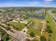 A picturesque aerial view features a church, adjacent sports field, lake, and nearby residential area at 13130 Meergate Cir, Orlando, FL 32837