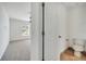 Half bathroom featuring tile floors and standard toilet and adjacent to a carpeted bedroom at 13130 Meergate Cir, Orlando, FL 32837