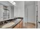 Bathroom showcasing double sinks with granite countertop and a walk-in shower behind the mirror at 13130 Meergate Cir, Orlando, FL 32837