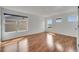 Well-lit bedroom with three windows providing ample light and hardwood floors at 13130 Meergate Cir, Orlando, FL 32837